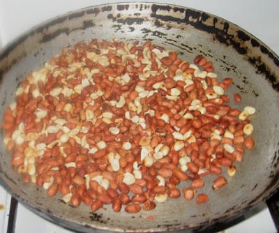Roasting groundnuts in a frying pan